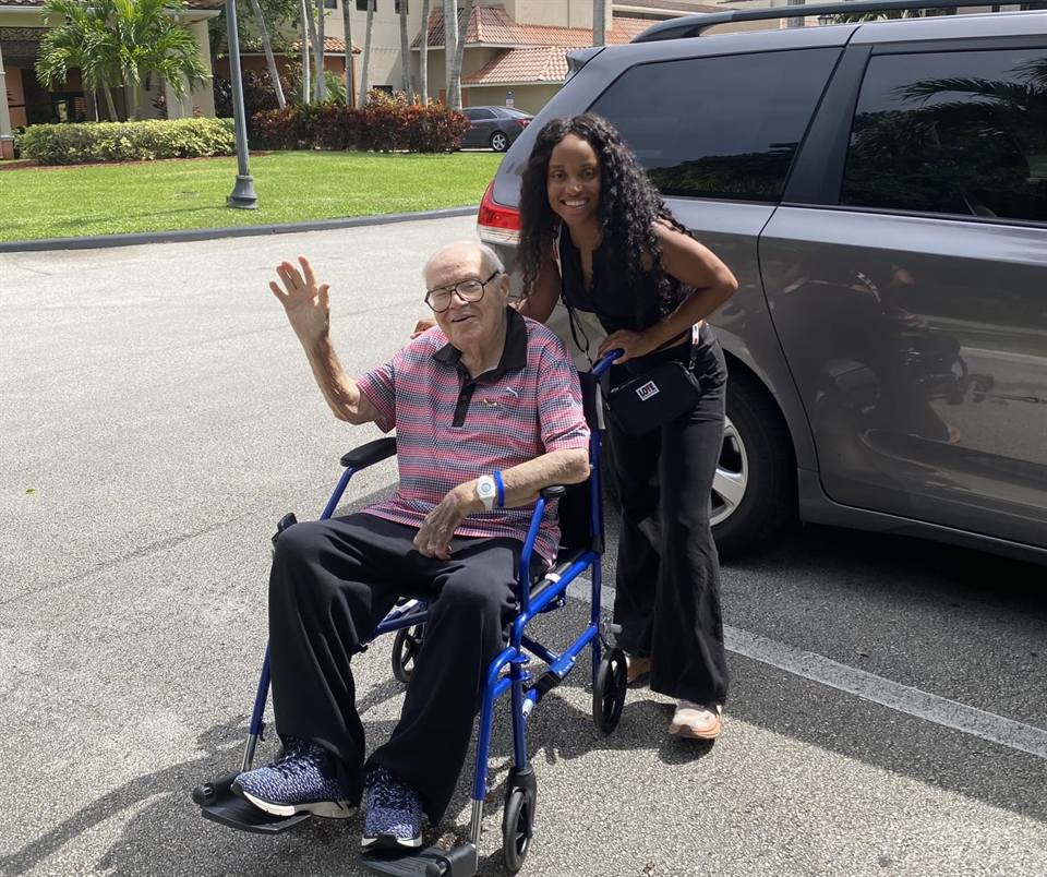 Family member holding hands with elderly loved one — family respite care in Palm Beach County